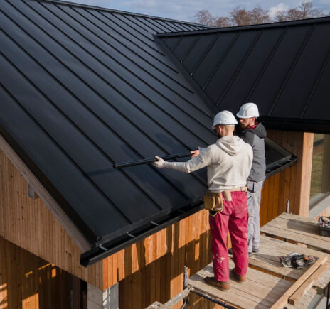 Full shot roofers working together with helmets